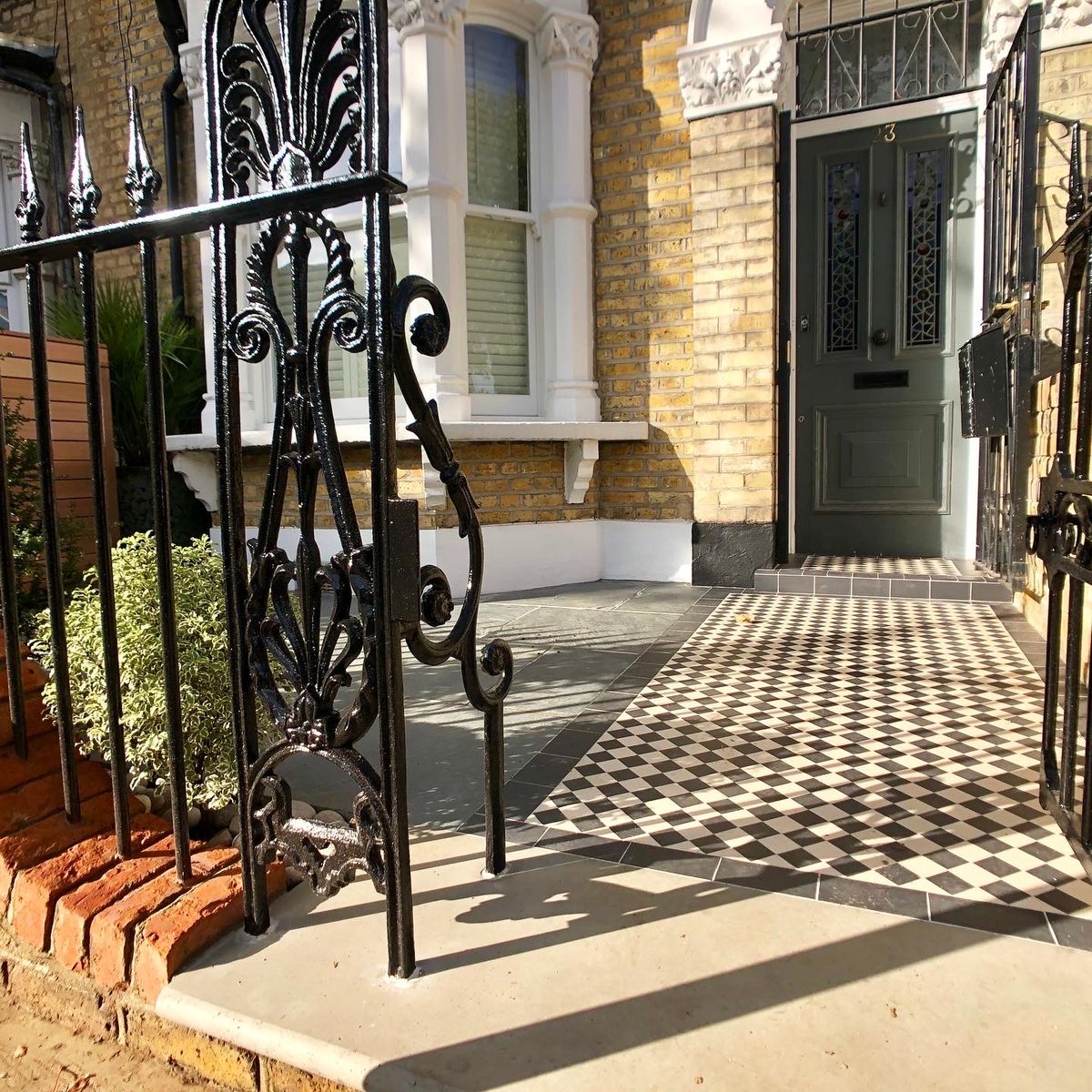 Small Front Yard Incorporating Decorative Cast Iron Panel and Victorian Tile Path