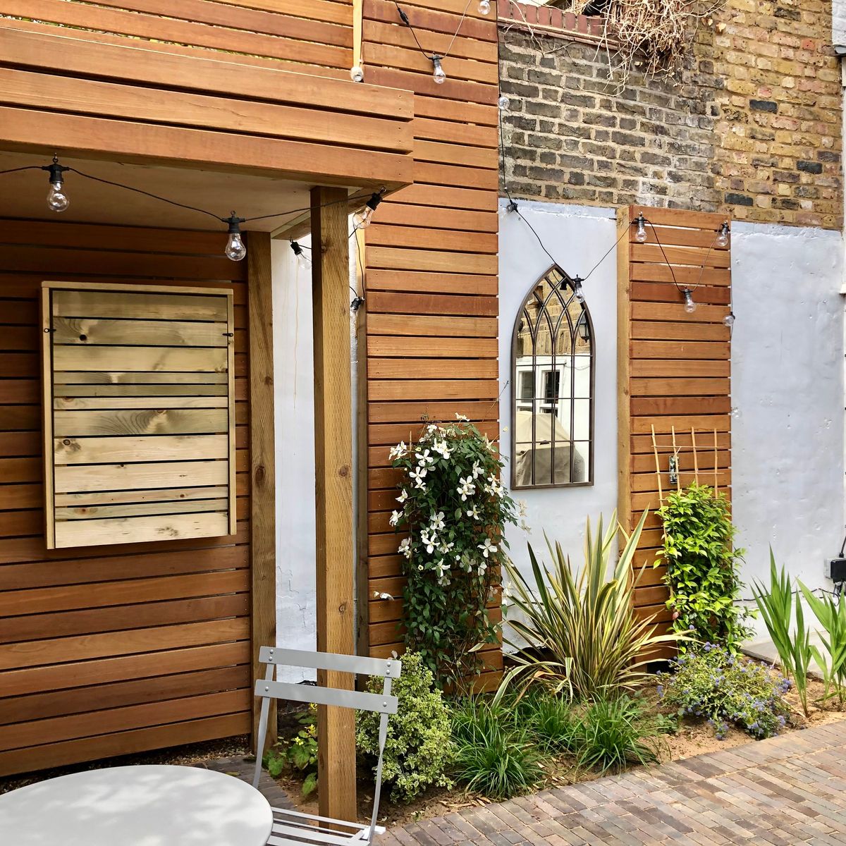 Softening Hardscape Design Elements with Robust Planting Design Including Phormium Tenax and Pittosporum in Hackney Central North London Garden