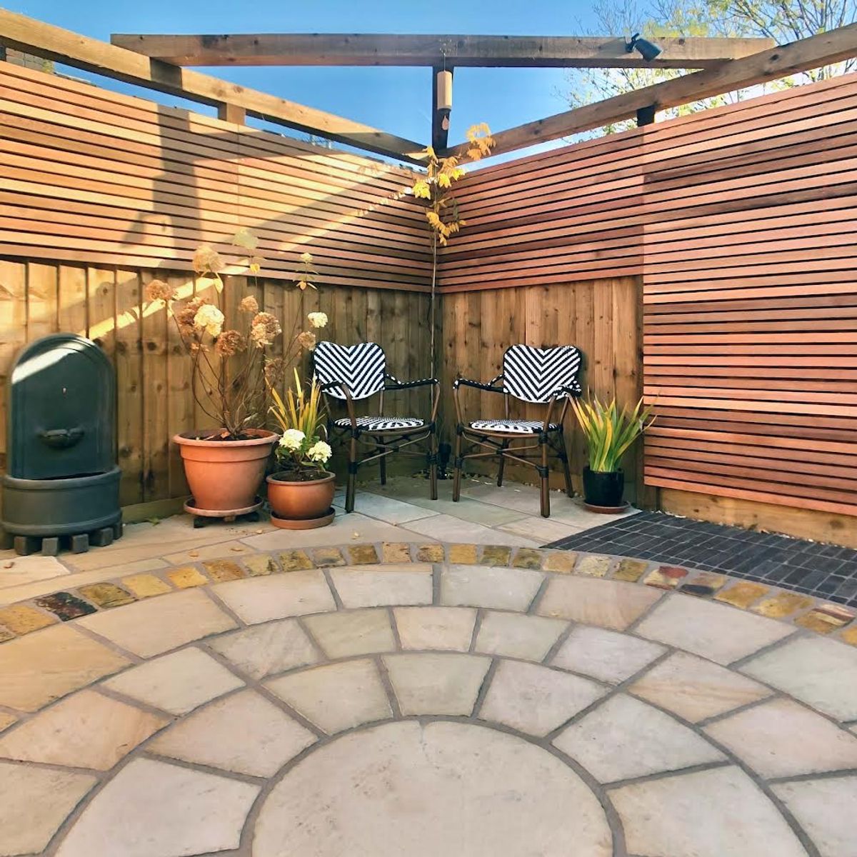 Detail of Seating Area with Triangular Oak Pergola and Cedar Fencing Part of Back Yard Design in Dalston North London